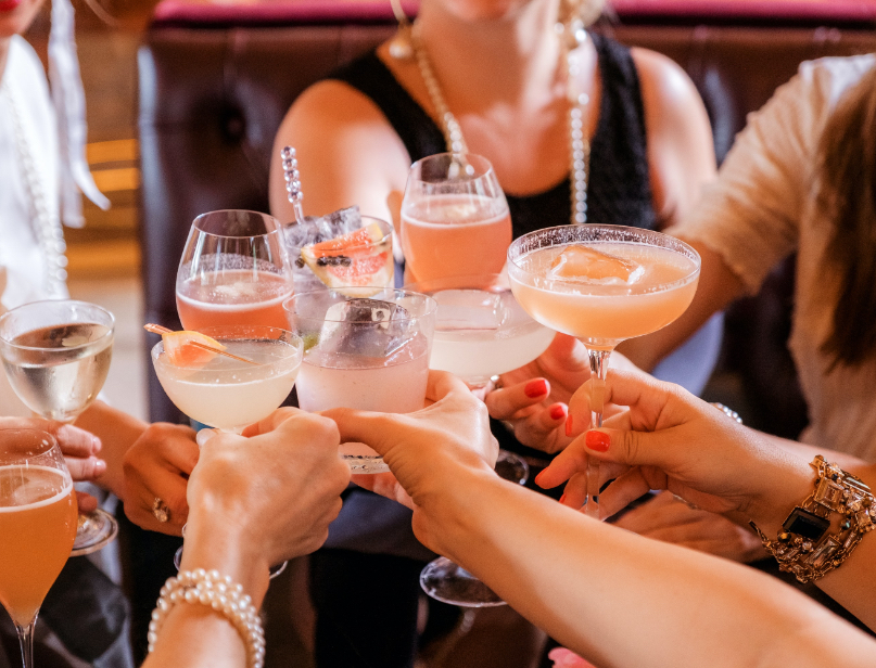 People clinking cocktail glasses