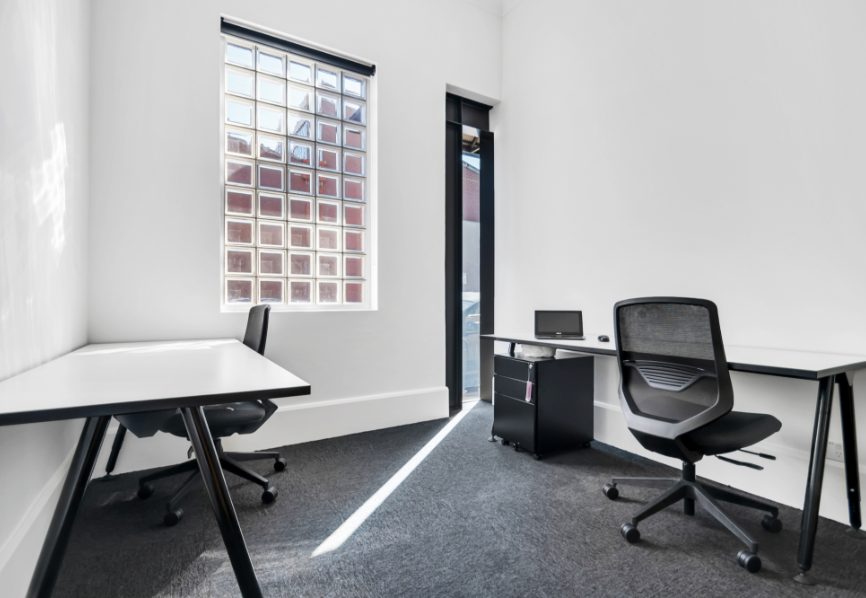 Photo of two desks in office at The Consortium