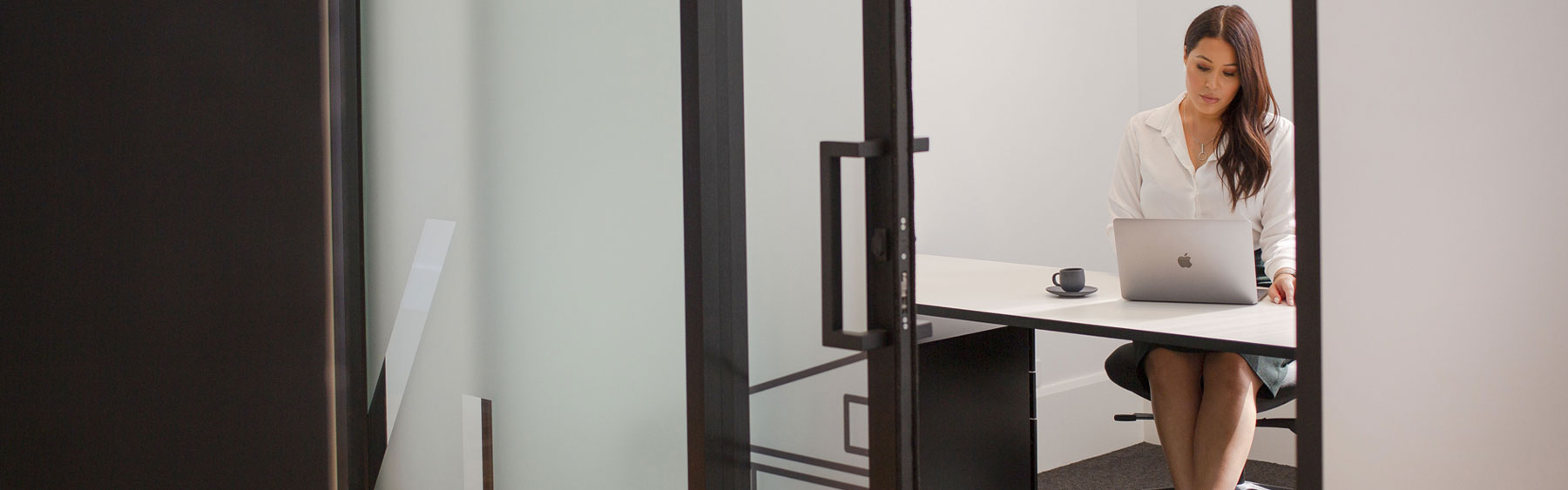 Photo of person working in an office suite in The Consortium